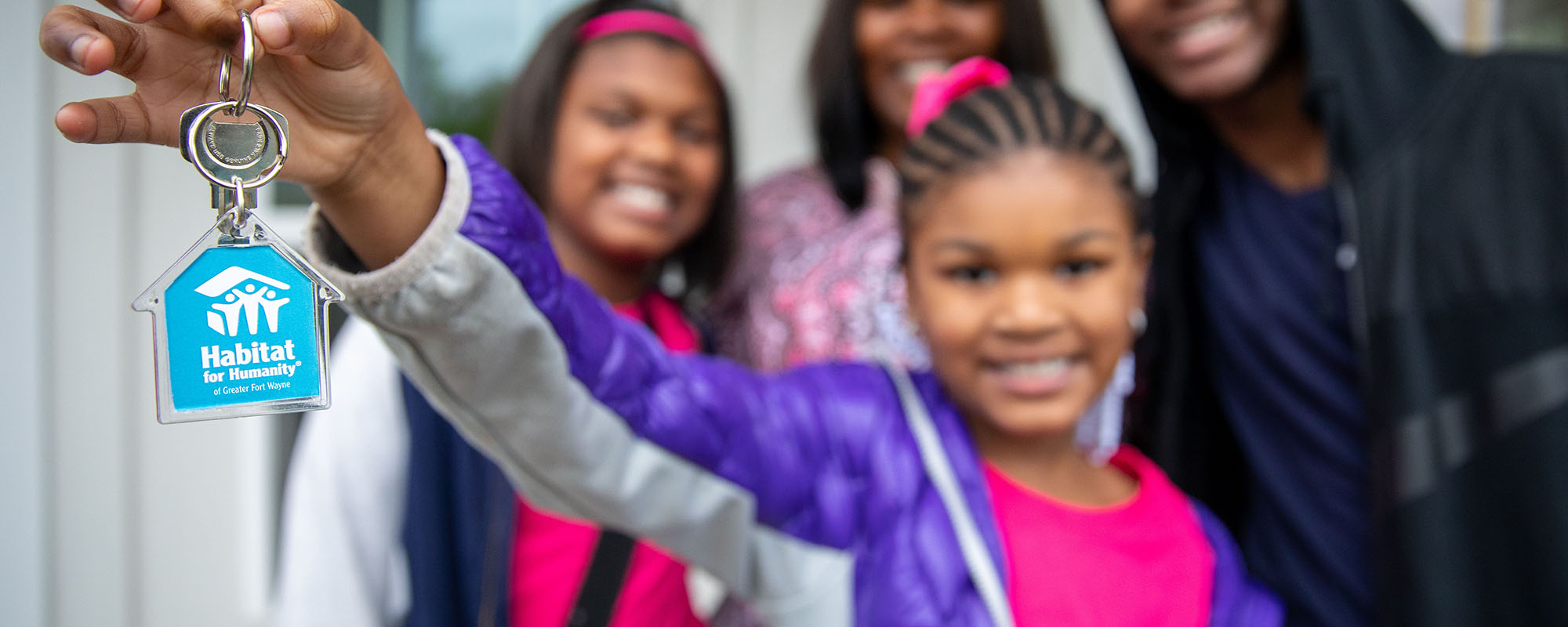 Girl with family holding Habitat key