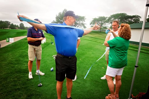 Golf player measuring wing span