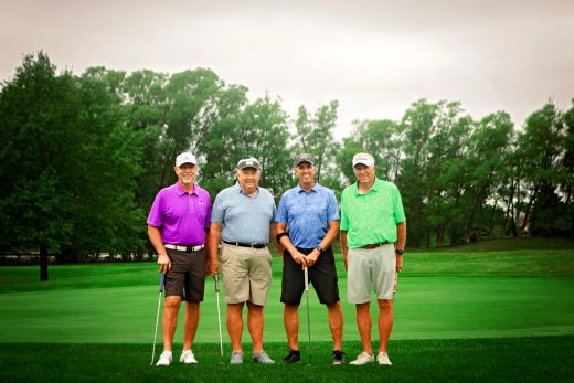 four male golfers at golf outing event