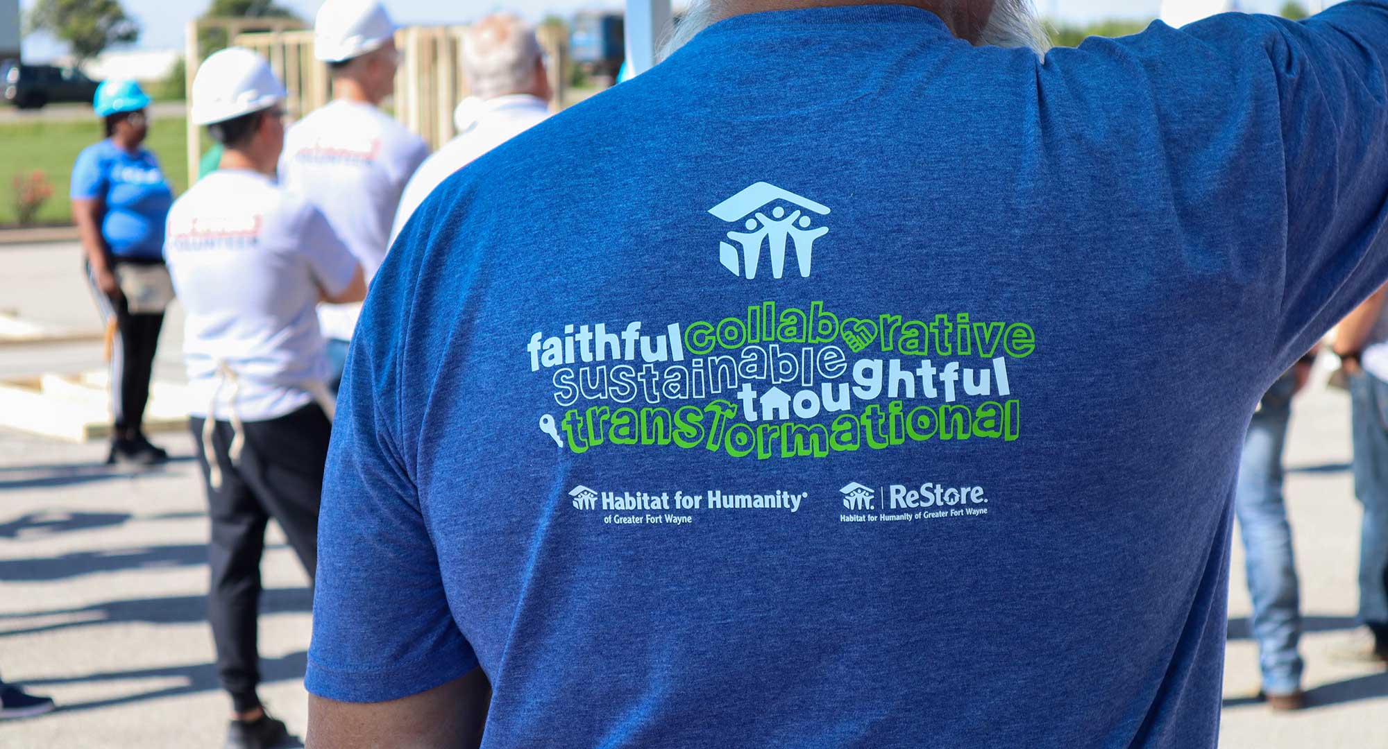 Back of shirt reads "Faithful, collaborative, sustainable, thoughtful, transformational"