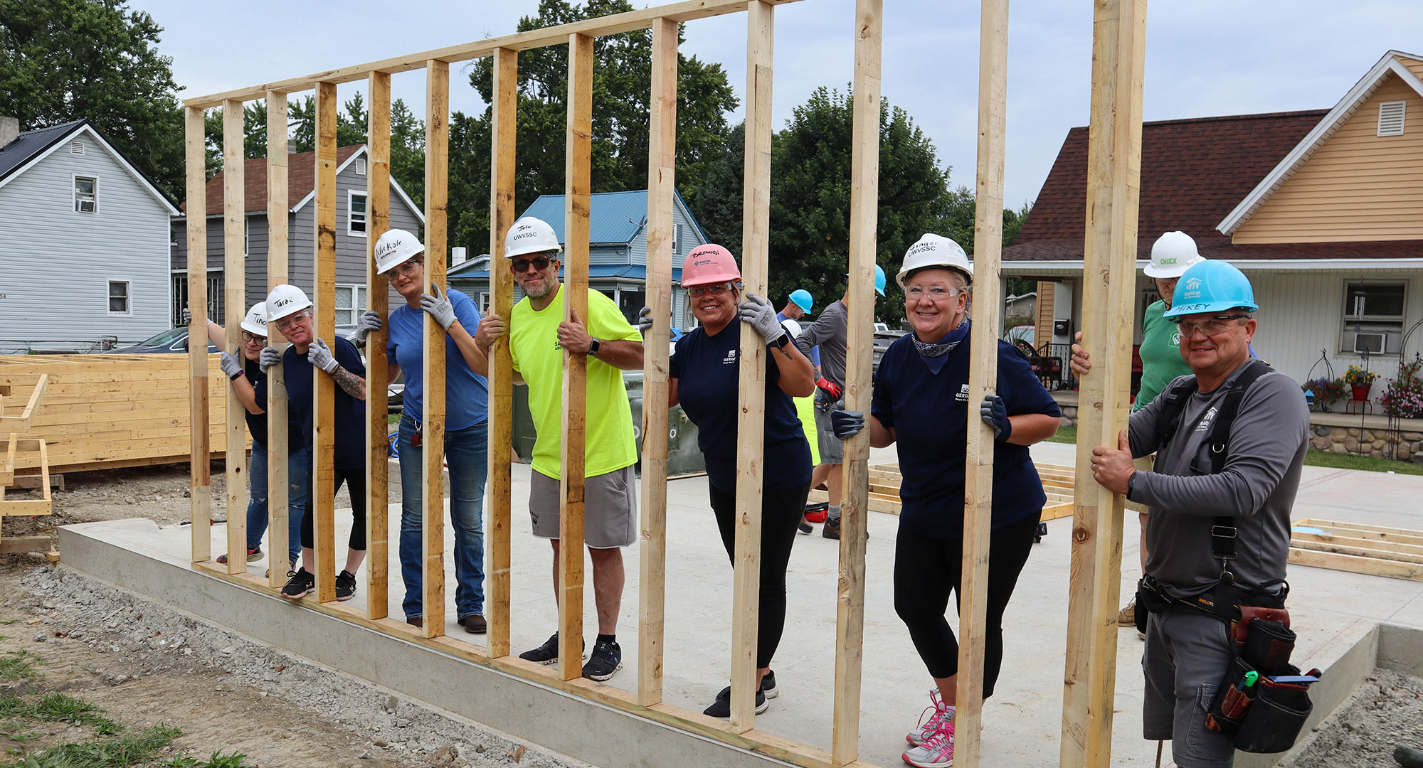 Huntington volunteers holding up wall