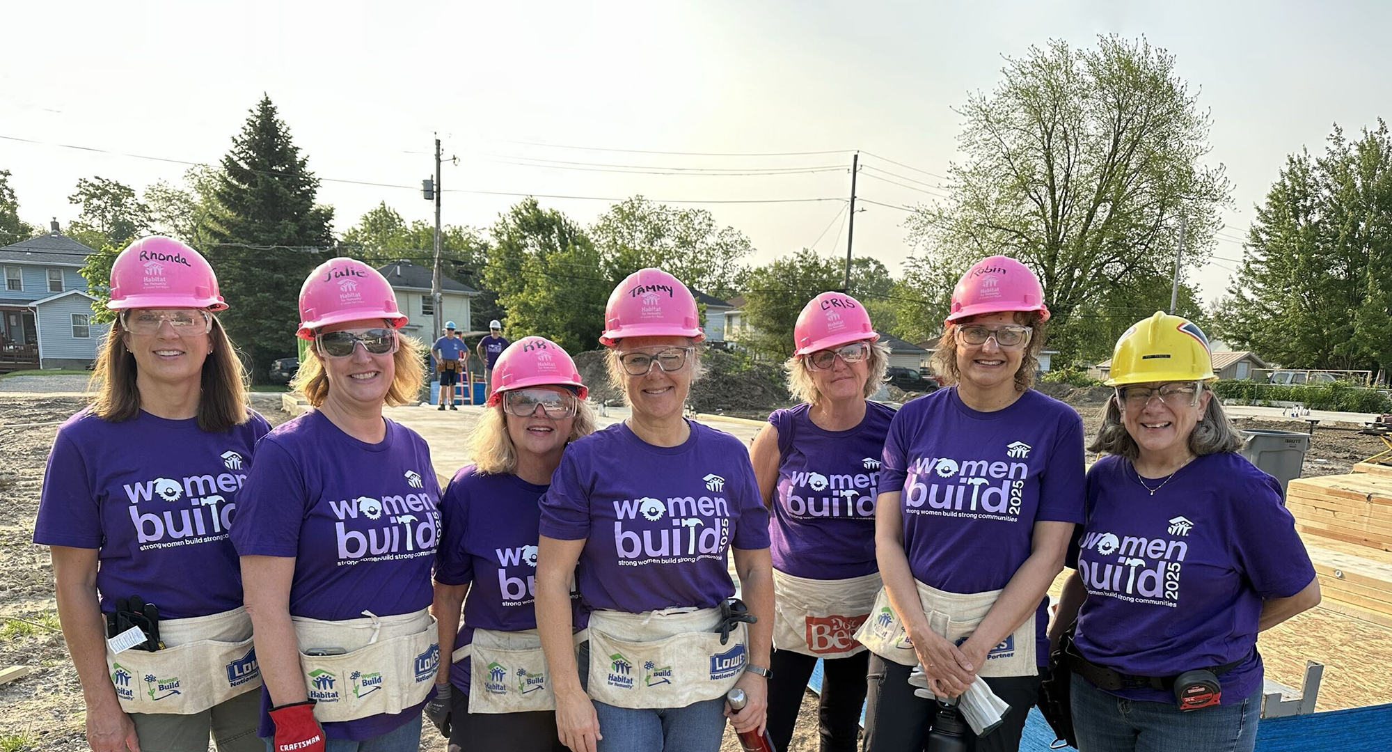 Women Build volunteers in pink hard hats
