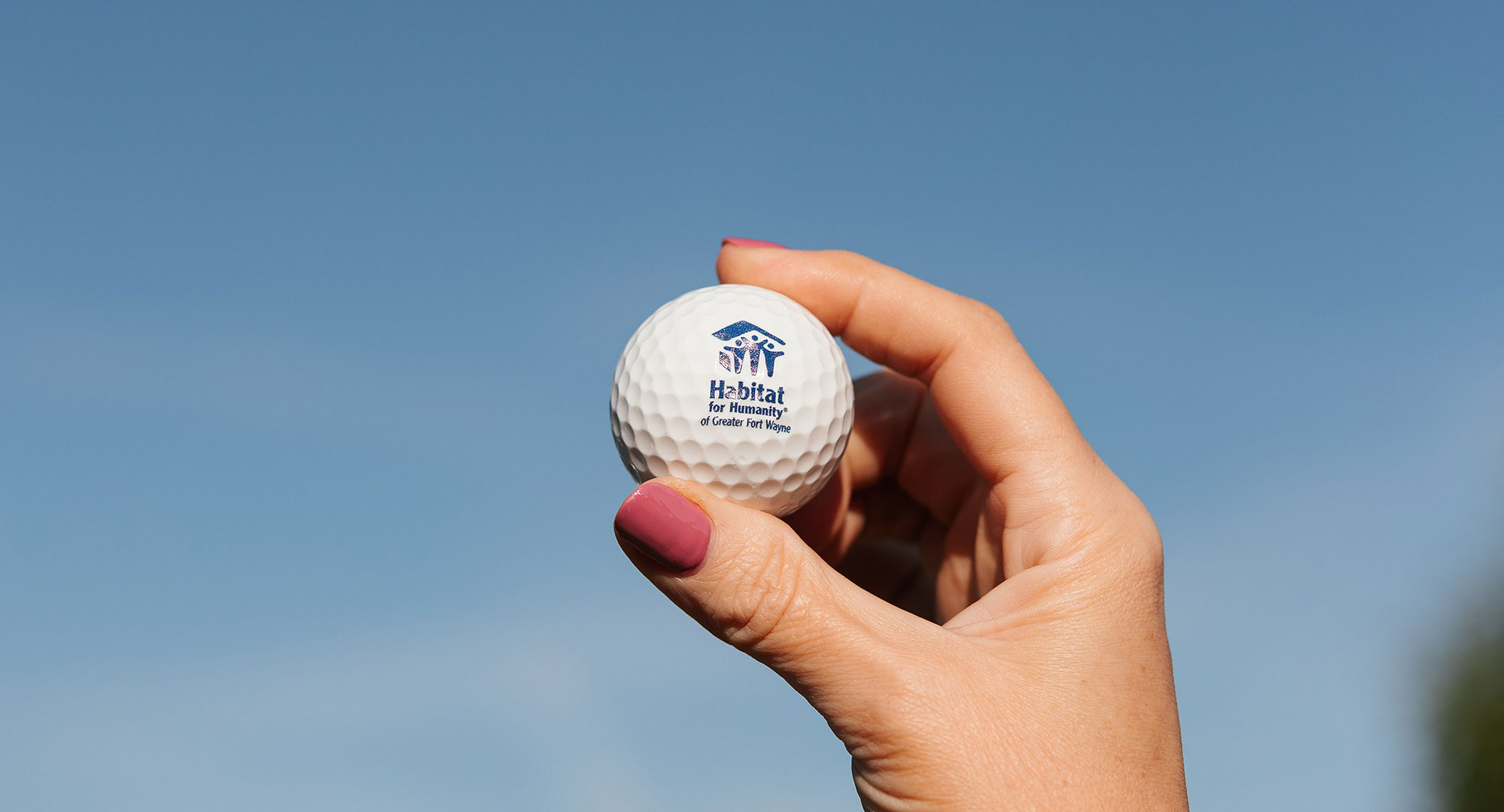 Hand holding golf ball
