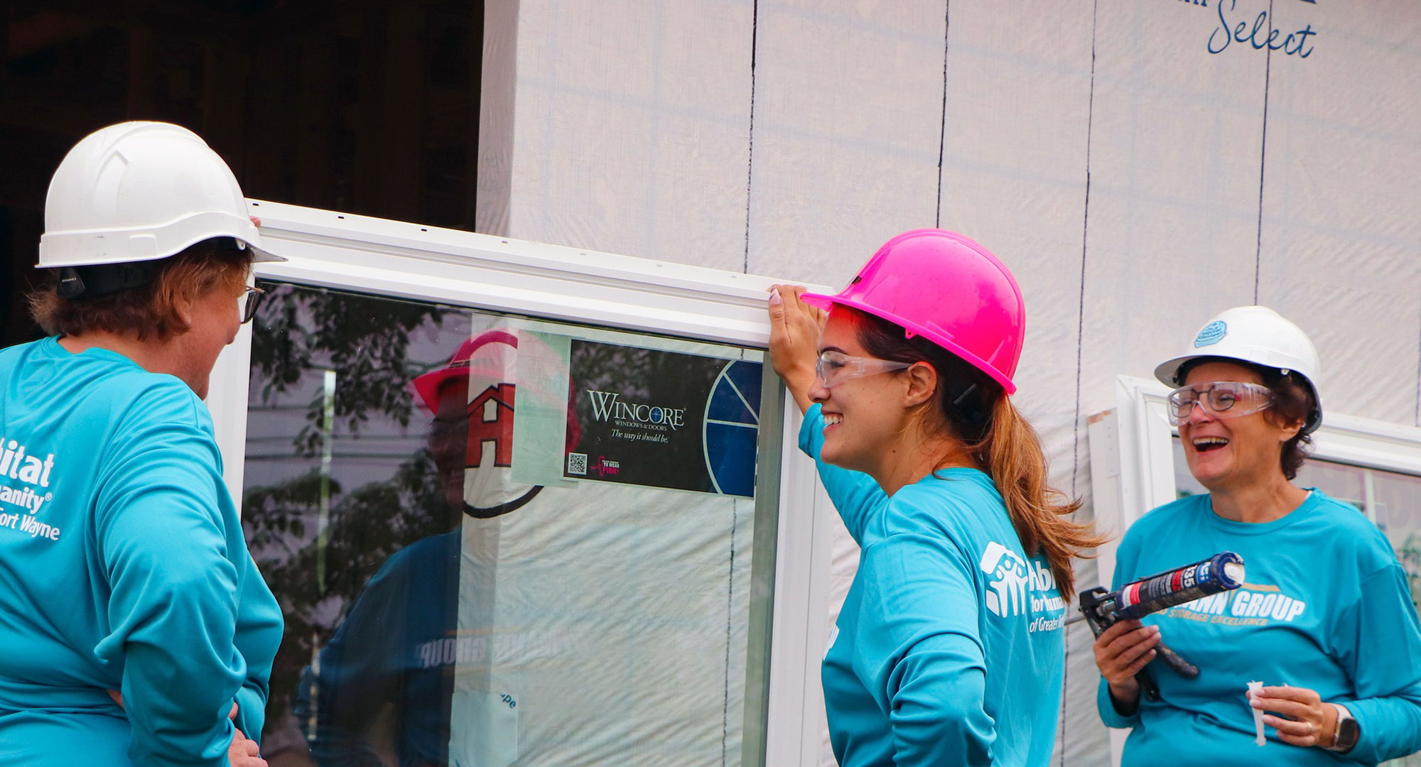 Volunteers installing window