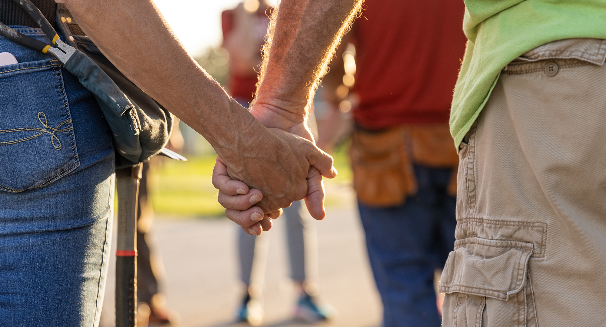 Volunteers holding hands